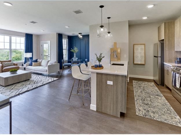 a kitchen and living room with a couch and a table
